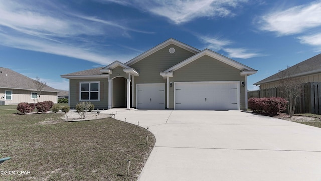 ranch-style home with a garage and a front lawn