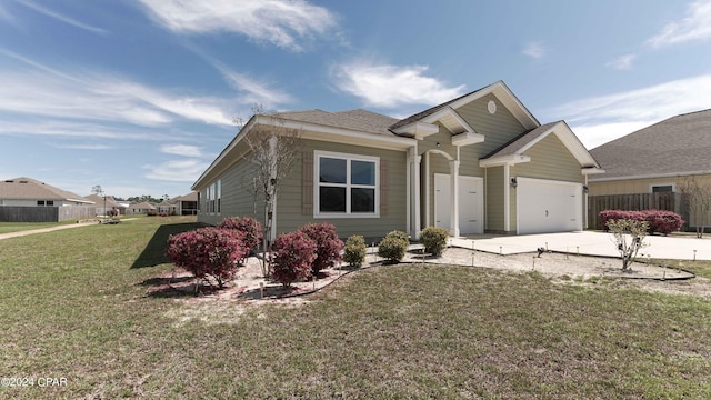 view of front of house featuring a front yard and a garage