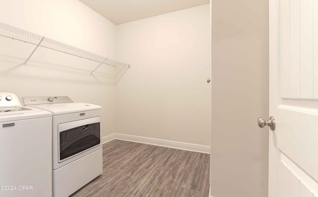 laundry room with hardwood / wood-style flooring and separate washer and dryer