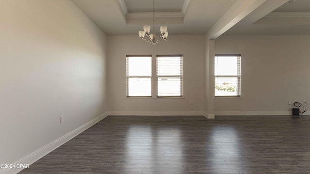 empty room with an inviting chandelier, a tray ceiling, dark wood-type flooring, and ornamental molding