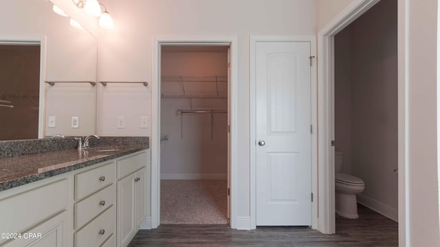 bathroom with vanity, hardwood / wood-style floors, and toilet