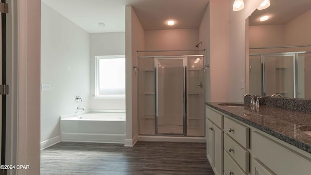 bathroom featuring hardwood / wood-style flooring, vanity, and independent shower and bath