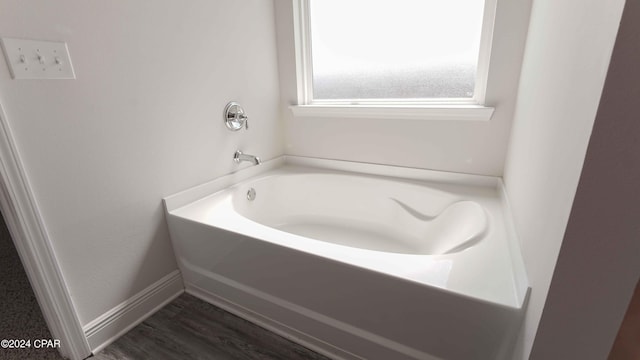 bathroom featuring a bathing tub and hardwood / wood-style floors