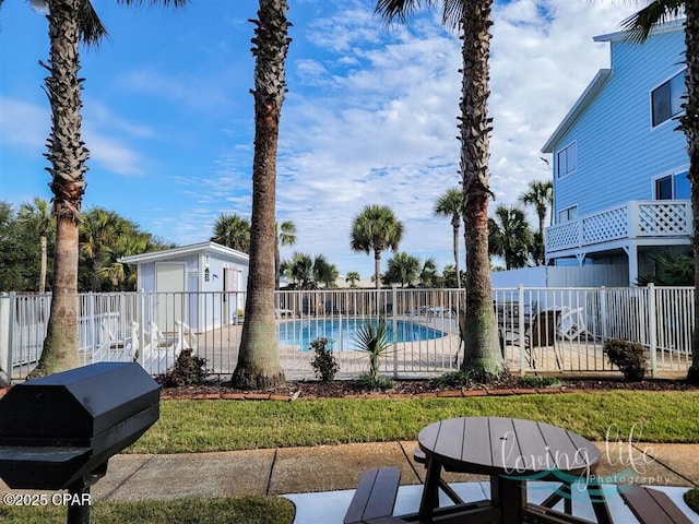 view of swimming pool featuring grilling area and a patio