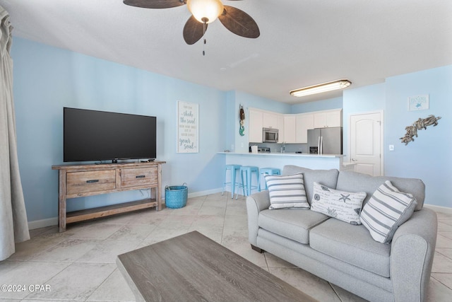 living room with ceiling fan and light tile floors