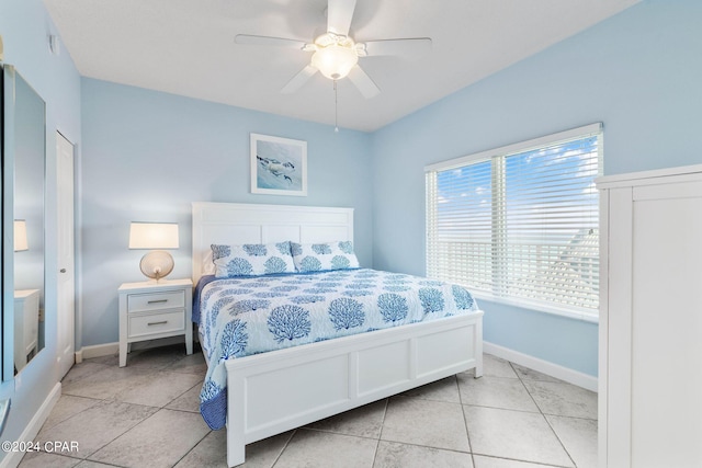 bedroom featuring ceiling fan and light tile floors