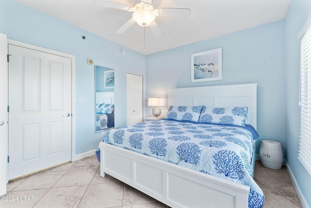 tiled bedroom with a closet and ceiling fan