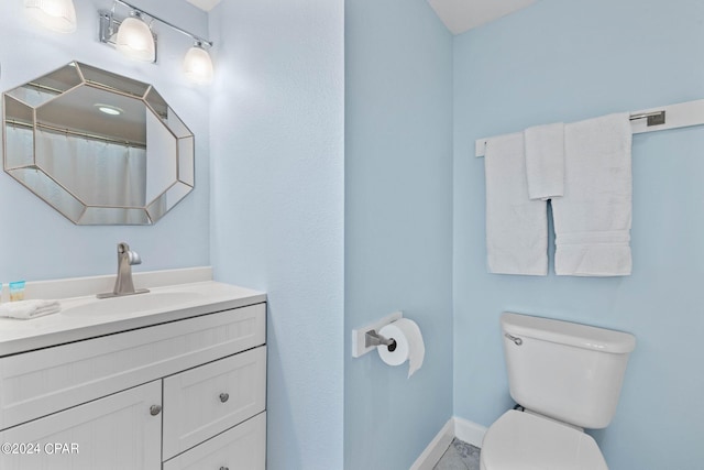 bathroom featuring toilet and large vanity