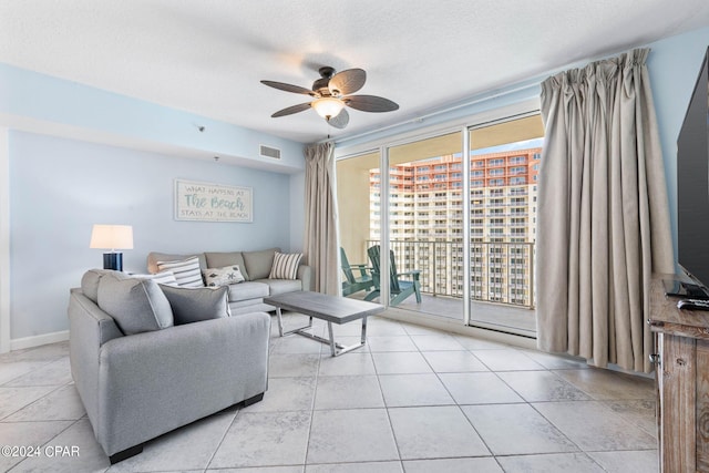 tiled living room with a textured ceiling and ceiling fan