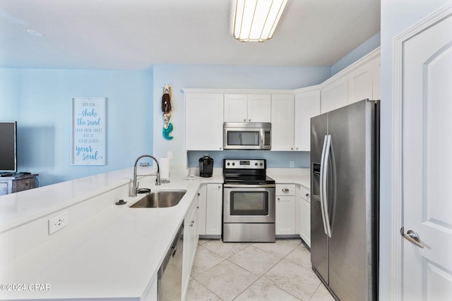 kitchen featuring stainless steel appliances, white cabinets, sink, and light tile floors