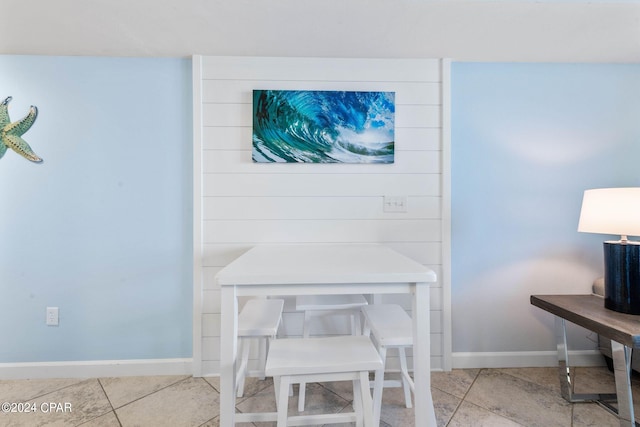 dining space featuring light tile floors