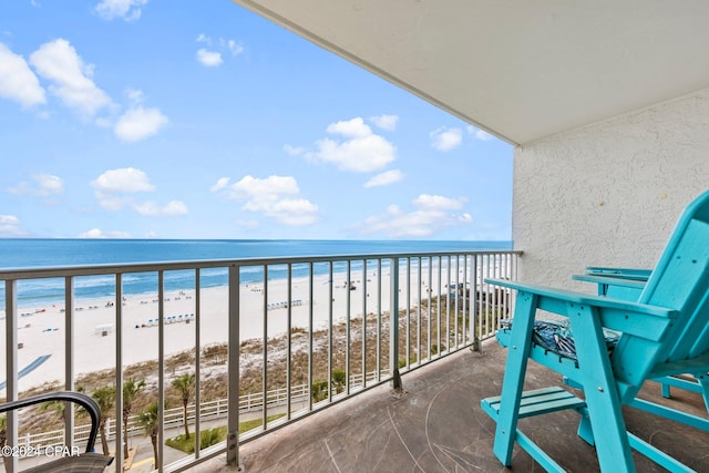 balcony featuring a water view and a view of the beach