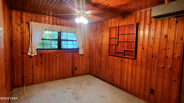 unfurnished room with ceiling fan, wooden ceiling, and wood walls