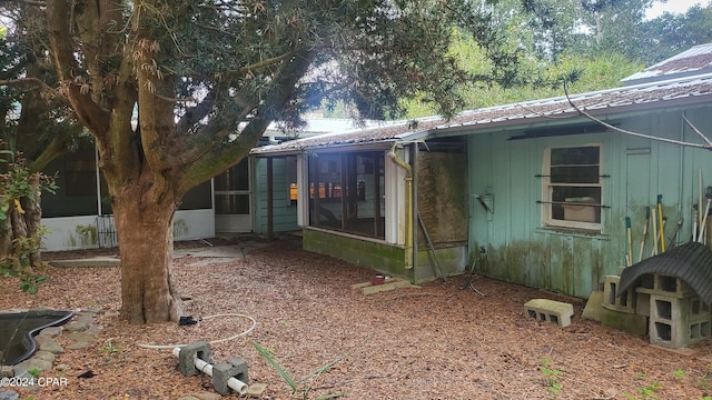 back of property featuring a sunroom