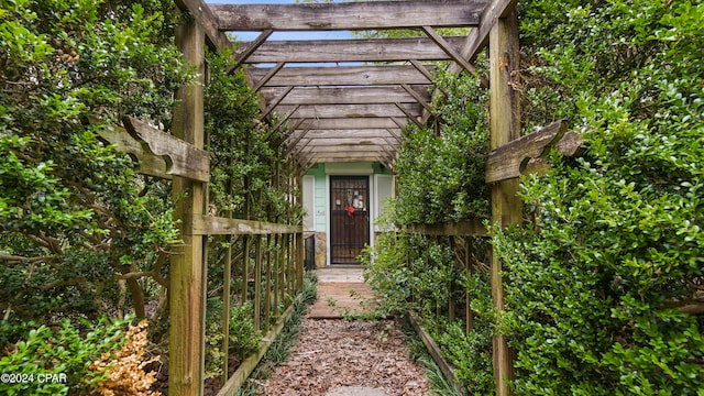 doorway to property featuring a pergola