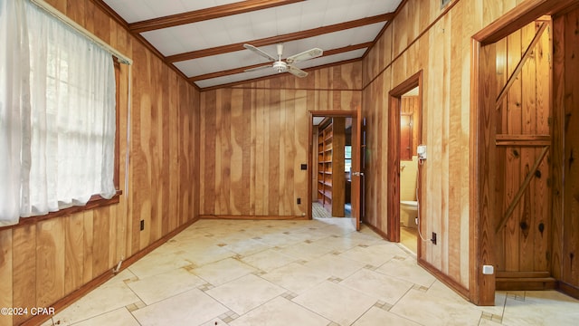 spare room featuring ceiling fan, light tile patterned floors, wooden walls, and lofted ceiling with beams