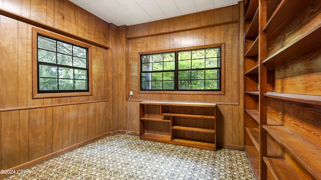 interior space featuring wood walls and light tile patterned floors