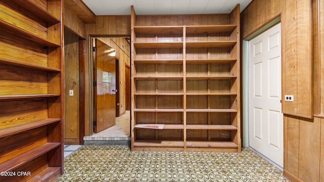 walk in closet with light tile patterned floors