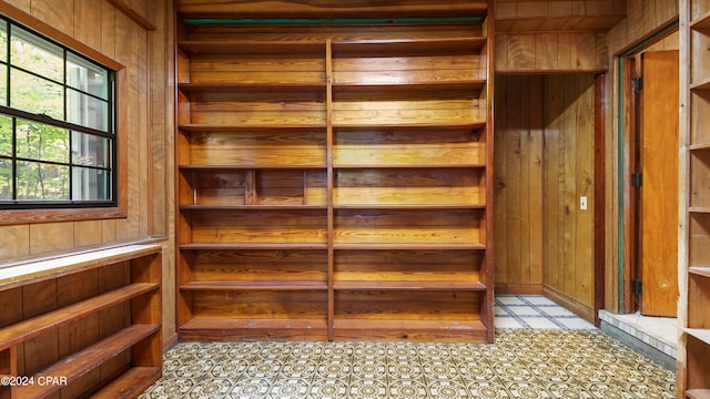 interior details featuring wood walls and tile patterned flooring