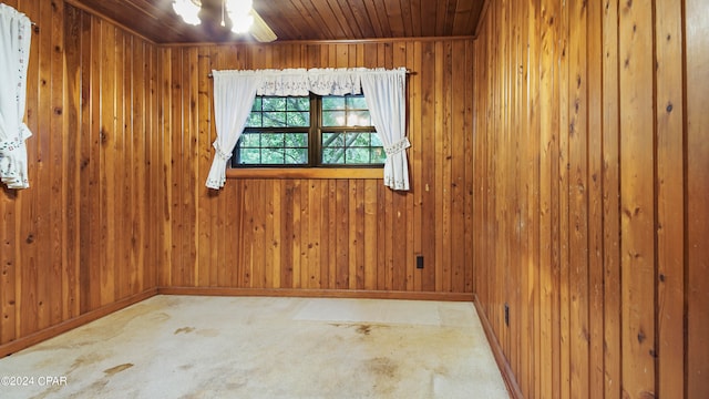 carpeted empty room with wood walls and wooden ceiling