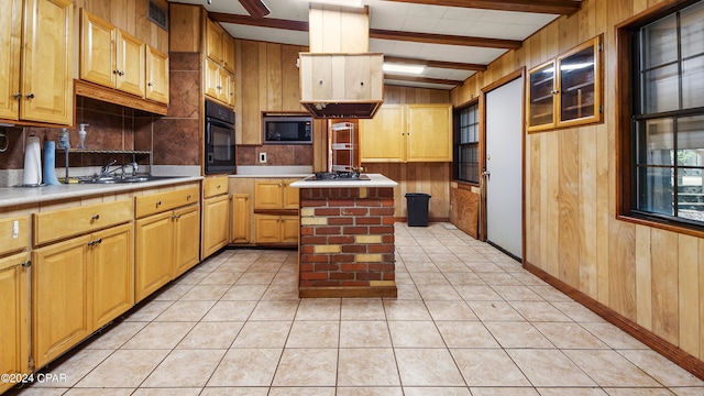 kitchen featuring appliances with stainless steel finishes, light tile patterned flooring, lofted ceiling with beams, and a center island