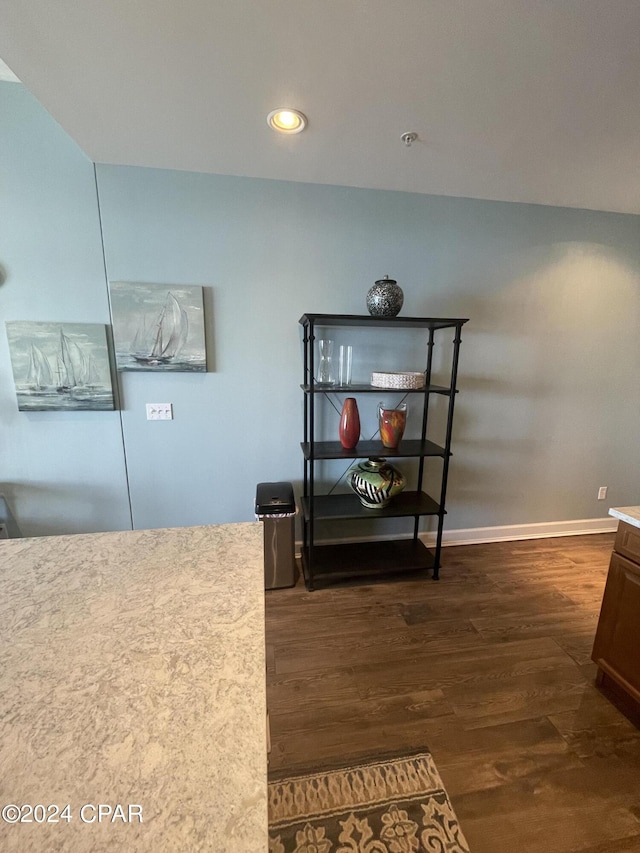 interior space featuring recessed lighting, baseboards, and wood finished floors