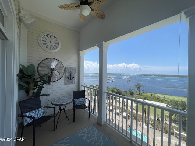 balcony featuring a ceiling fan and a water view