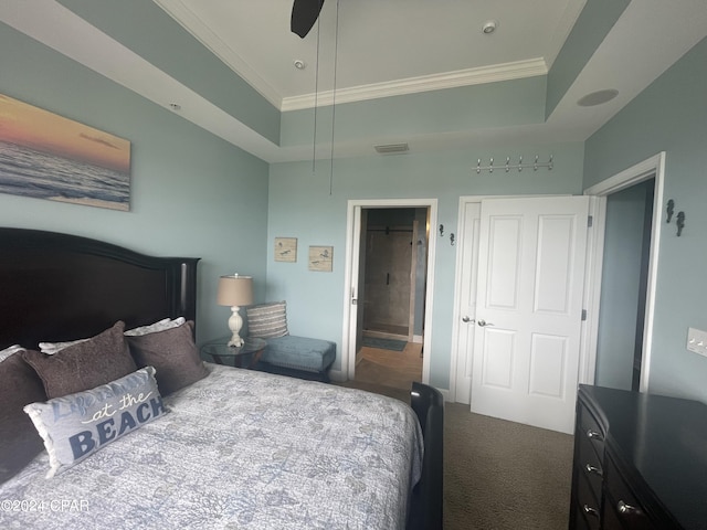 bedroom with a tray ceiling, carpet, visible vents, and crown molding