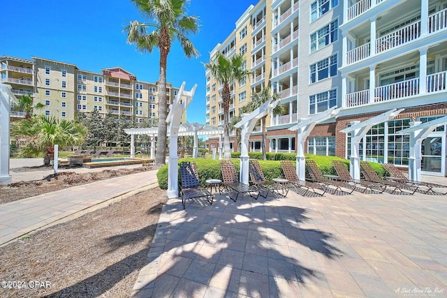 view of property's community featuring a patio area and a pergola