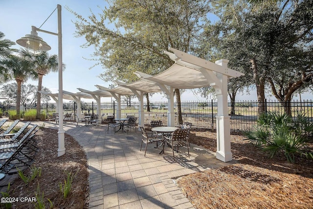 view of home's community with a patio area, fence, and a pergola