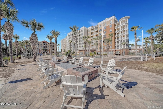 view of patio / terrace with a view of city and an outdoor fire pit