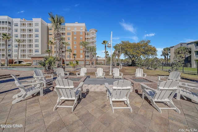 view of patio / terrace with a fire pit and a community pool