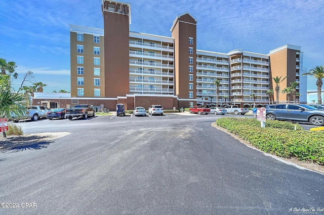 view of property featuring uncovered parking