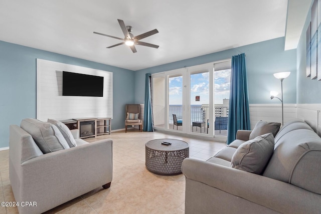 living room featuring light tile floors and ceiling fan