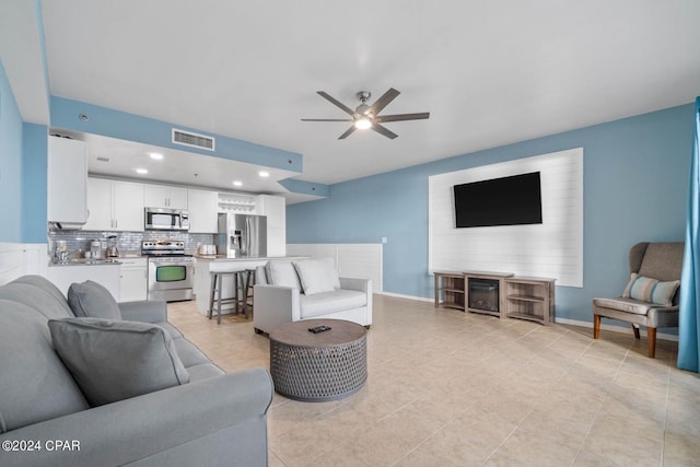 tiled living room with ceiling fan