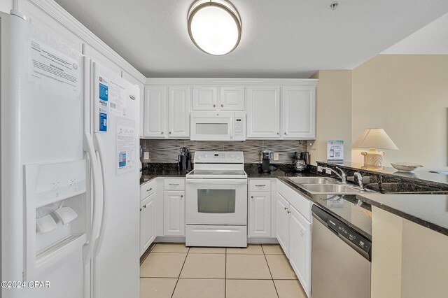 kitchen with sink, white appliances, white cabinetry, backsplash, and light tile patterned flooring