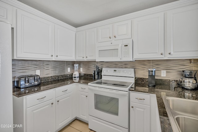 kitchen featuring light tile patterned flooring, tasteful backsplash, sink, white cabinets, and white appliances