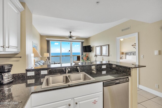 kitchen with white cabinetry, dishwasher, sink, and dark stone countertops