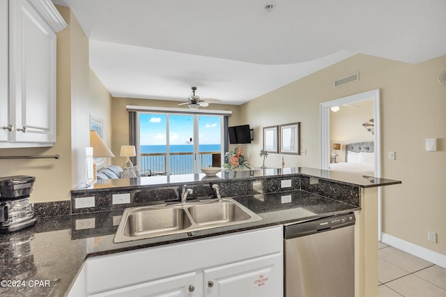 kitchen with dishwasher, sink, white cabinets, and dark stone counters