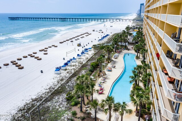 birds eye view of property featuring a water view and a beach view