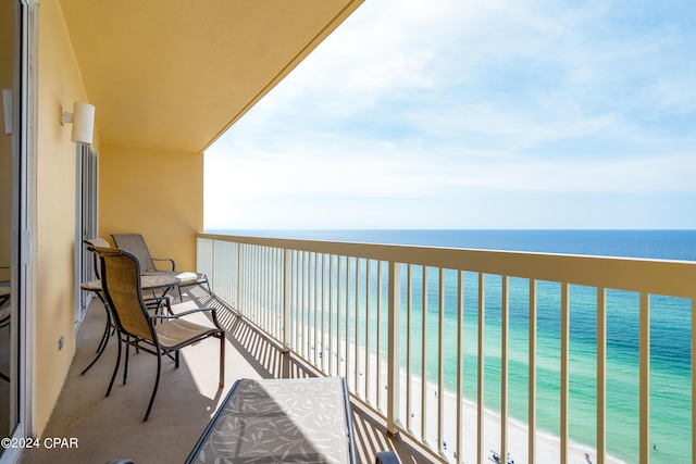 balcony with a water view and a beach view