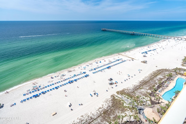 birds eye view of property featuring a water view and a beach view