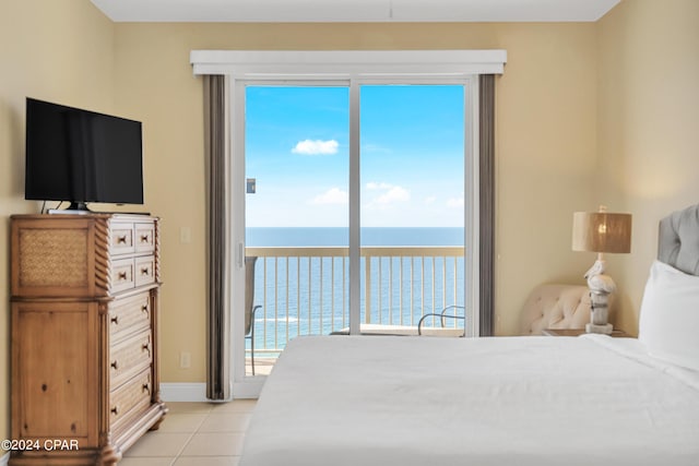 tiled bedroom featuring a water view and access to exterior