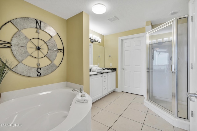 bathroom with vanity, tile patterned flooring, and plus walk in shower