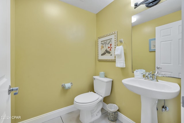 bathroom featuring sink, toilet, and tile patterned flooring