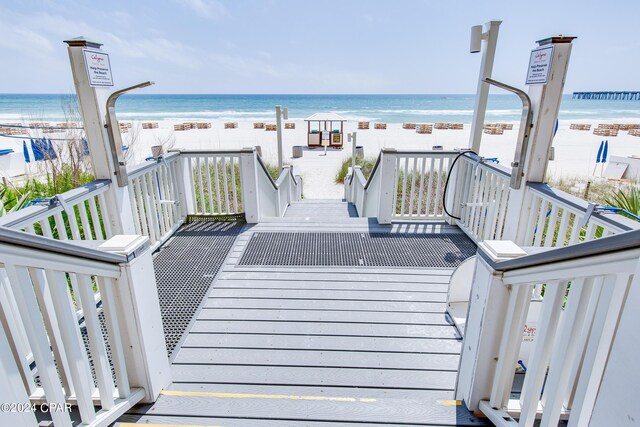 deck featuring a water view and a view of the beach