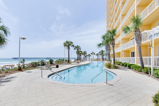 view of swimming pool with a water view