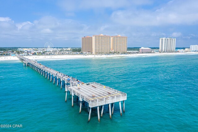 drone / aerial view featuring a water view and a beach view