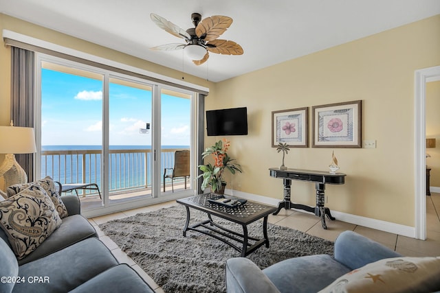 tiled living room with ceiling fan