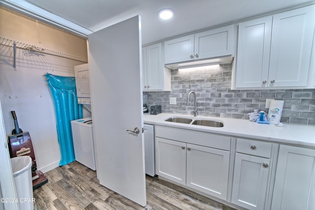 kitchen with white cabinets, backsplash, white dishwasher, dark hardwood / wood-style floors, and sink